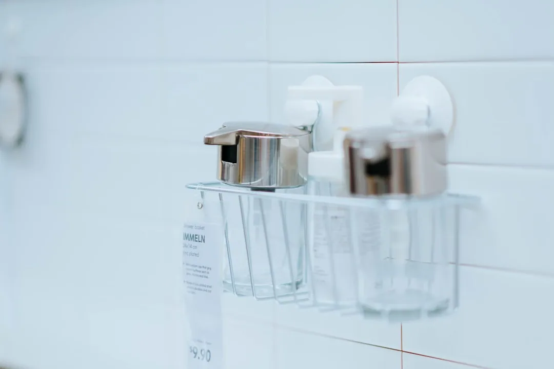 Person Wiping Down A Bathroom Sink With Cloth