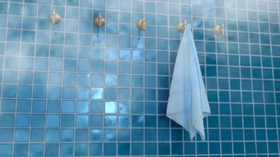 Cleaning shower walls of tile, glass, acrylic, and stone with appropriate tools and cleaners