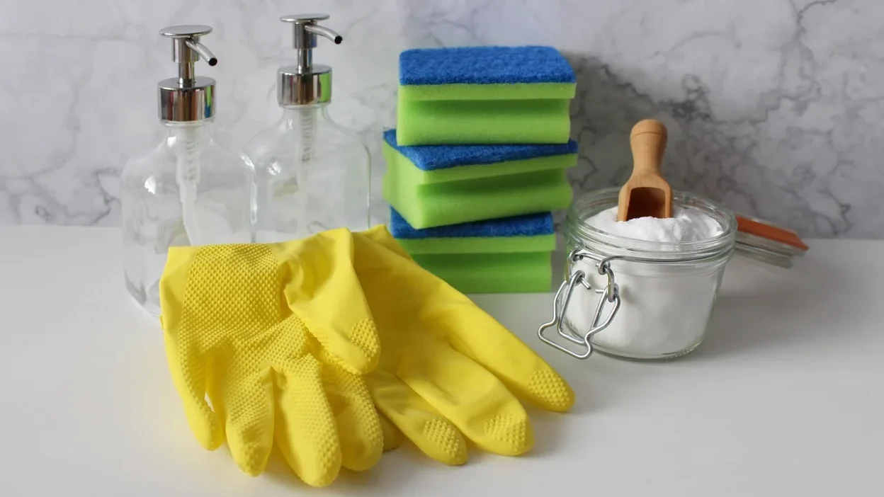 A checklist and cleaning supplies on a table, illustrating how to avoid common cleaning order mistakes.