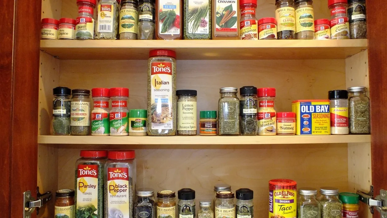 Proper storage of cleaning supplies in a humid bathroom with airtight containers and a dehumidifier.