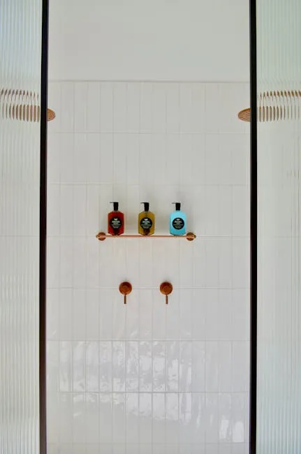 Person Cleaning Shower Tiles With Spray Bottle